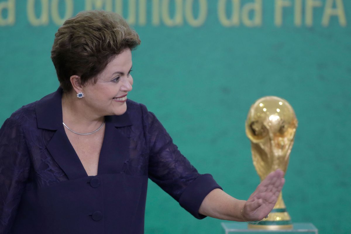 FILE - In this June 2, 2014, file photo, Brazil's President Dilma Rousseff waves to children at a ceremony where FIFA President Sepp Blatter presented the 2014 World Cup trophy to Rousseff at the Planalto presidential palace, in Brasilia, Brazil. President Rousseff has taken to the nation's airwaves Tuesday June 10, 2104, to deliver a pre-taped address trying to rally the nation behind the World Cup that begins this week. (AP Photo/Eraldo Peres,File) (AP)