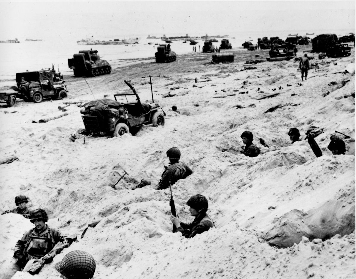 This June 6, 1944, file photo shows American soldiers of the Allied Expeditionary Force securing a beachhead during initial landing operations at Normandy, France, June 6, 1944.  From the first sketchy German radio broadcast to the distribution of images filmed in color, it has taken decades for the full story of the D-Day invasion to come out. At the time, the reporting, filming and taking of photos was neither easy nor straightforward. (AP Photo/Weston Haynes, File) (AP)