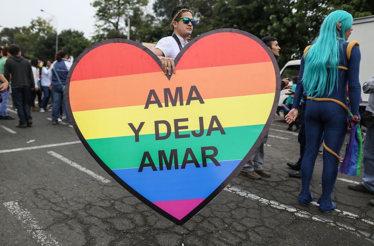 A man carries a heart that reads in Spanish "Love and let love" at a gay pride parade in Lima, Peru, Saturday, June 28, 2014. Gays, lesbians and transgenders are holding gay pride parades worldwide this month as part of annual demonstrations demanding equal rights and to protest discrimination. (AP Photo/Sebastian Castaneda) (AP)