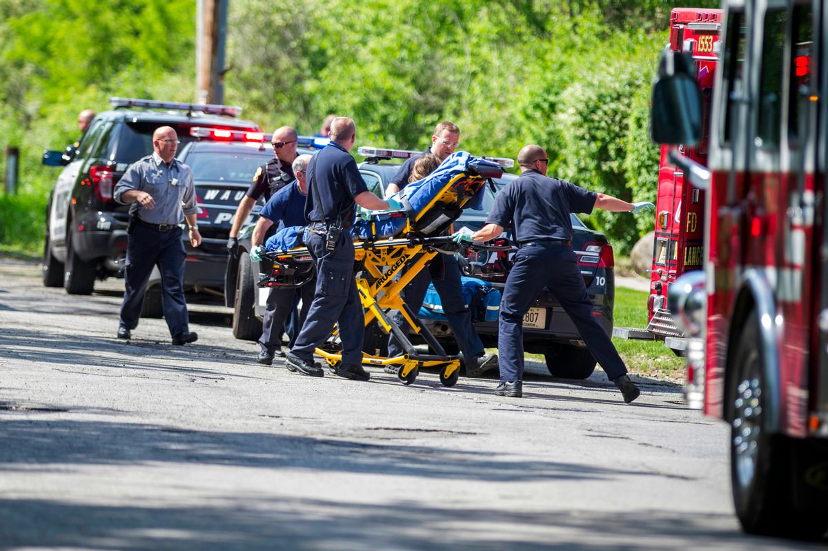 In this Saturday, May 31, 2014 photo, rescue workers take a stabbing victim to the ambulance in Waukesha, Wis.  (AP/Abe Van Dyke)