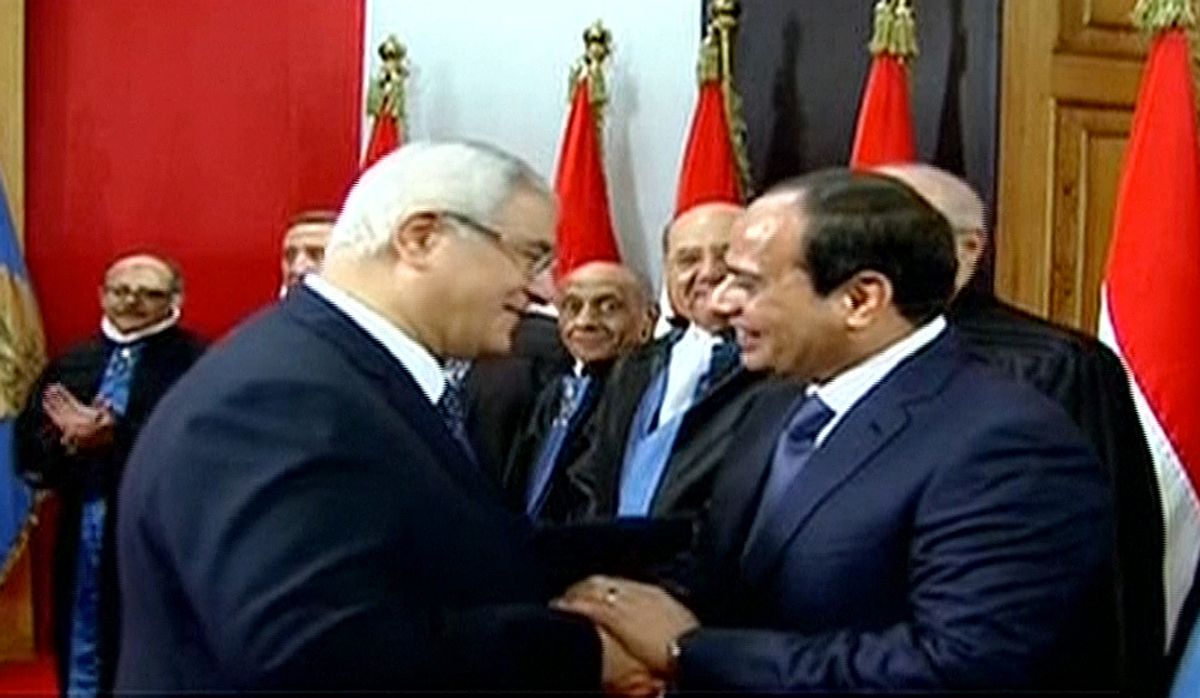 This image made from Egyptian State Television shows newly sworn in President Abdel-Fattah el-Sissi, right, being congratulated by outgoing interim President Adly Mansour, center left, after a ceremony at the Supreme Constitutional Court in Cairo, Egypt, Sunday, June 8, 2014. El-Sissis inauguration Sunday comes less than a year after the 59-year-old career infantry officer ousted the countrys first freely elected president, the Islamist Mohammed Morsi, following days of mass protests by Egyptians demanding he step down. (AP Photo/Egyptian State Television) (AP)
