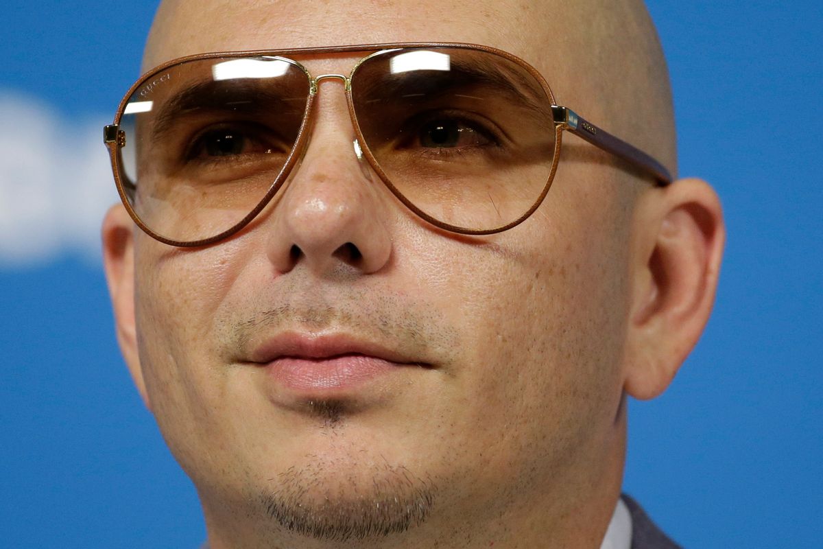 FILE - In this Wednesday, June 11, 2014, file photo, Cuban-American rapper Pitbull listens to a question during a news conference one day before the World Cup soccer tournament starts in Sao Paulo. Billboards recent Hot 100 chart reflects a group of hits that mainly showcase two types of songs: One written solely by an act and an additional songwriter, while others have seven or eight songwriters listed, such as Pitbulls Timber or Jason Derulos Wiggle. (AP Photo/Felipe Dana, File) (AP)