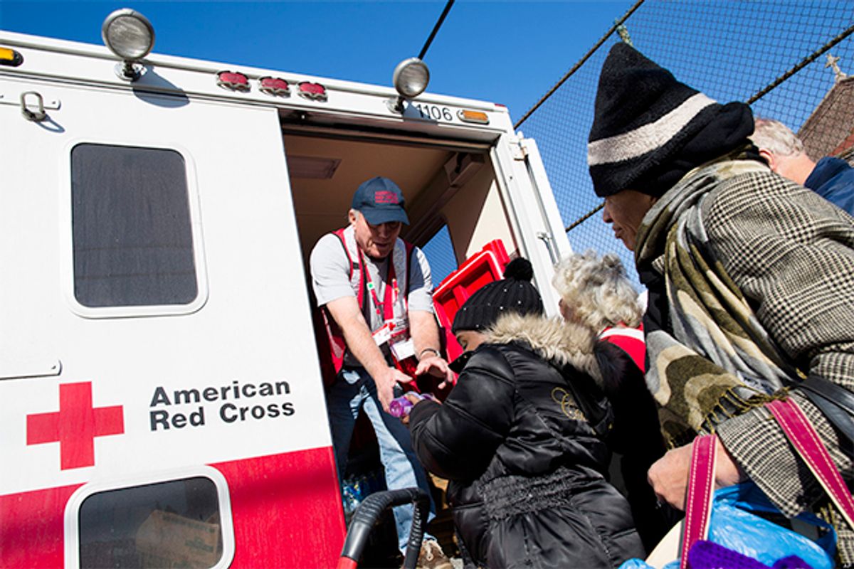 A member of the Red Cross distributes food to residents of Coney Island affected by Superstorm Sandy, Nov. 9, 2012.     (AP/John Minchillo)