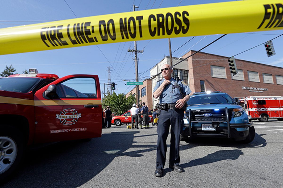 A police officer stands near the scene of a shooting on the campus of Seattle Pacific University Thursday, June 5, 2014, in Seattle.     (AP/Elaine Thompson)