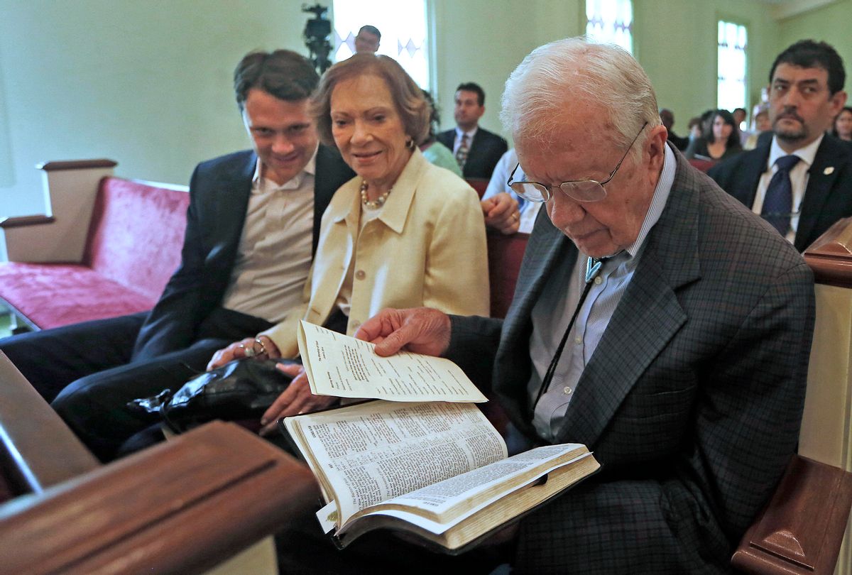 In this photo taken Sunday, June 8, 2014, Georgia Democratic gubernatorial candidate Jason Carter, left, sits with his grandparents Rosalynn and Jimmy Carter during a church service in Plains, Ga. Religion offers a powerful connection with many in the South, and Democrats looking to halt Republican gains in Georgia, Kentucky and elsewhere are finding their faith to be a valuable asset. (AP Photo/John Bazemore) (AP)