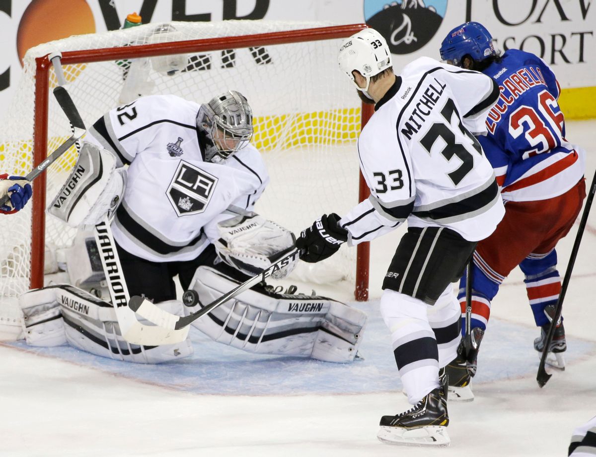 Los Angeles Kings goalie Jonathan Quick (32) blocks a shot by New York Rangers right wing Mats Zuccarello (36) as Kings defenseman Willie Mitchell (33) helps defend in the second period during Game 3 of the NHL hockey Stanley Cup Final, Monday, June 9, 2014, in New York. (AP Photo/Frank Franklin II) (Frank Franklin Ii)