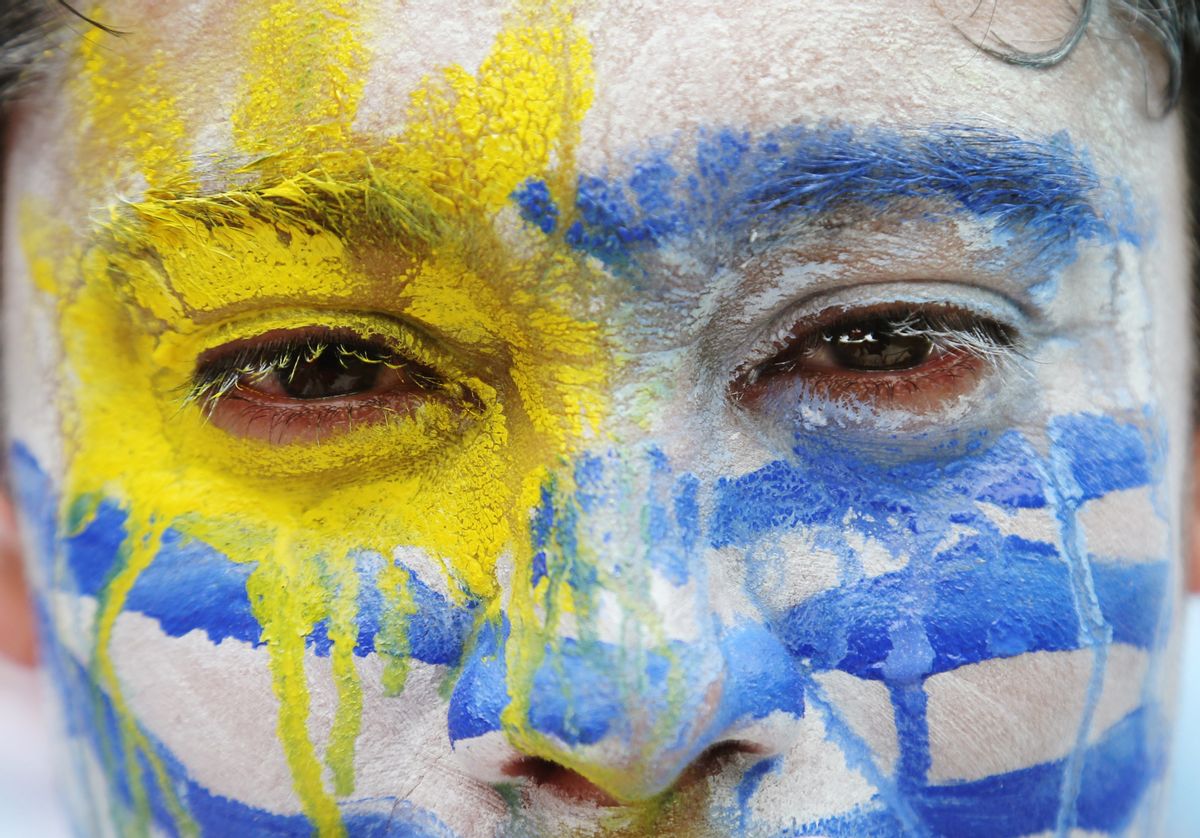 An Uruguay soccer fan wears face paint before the group D World Cup soccer match between Italy and Uruguay at the Arena das Dunas in Natal, Brazil, Tuesday, June 24, 2014. (AP Photo/Petr David Josek) (AP)