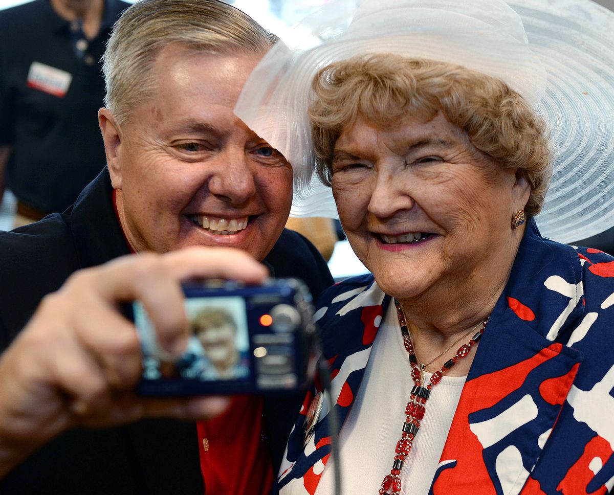 U.S. Sen. Lindsey Graham takes a "selfie" with MaryAnn Riley, right, following a campaign stop at the YMCA in Spartanburg, S.C., Monday, June 9, 2014. Graham made a final stop in Spartanburg before the primary election Tuesday. (AP Photo/Spartanburg Herald-Journal, Tim Kimzey) (AP)