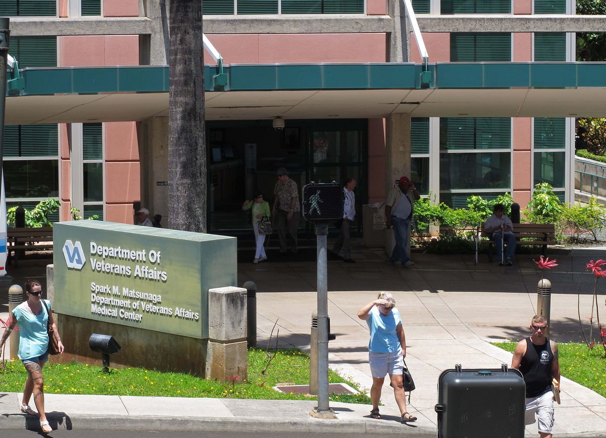 People stand outside the Spark M. Matsunaga VA Medical Center, Monday, June 9, 2014 in Honolulu. Hawaii had the longest wait time in the nation for veterans to get their first appointment with a primary care physician, according to data released by the U.S. Department of Veterans Affairs. (AP Photo/Oskar Garcia) (AP)