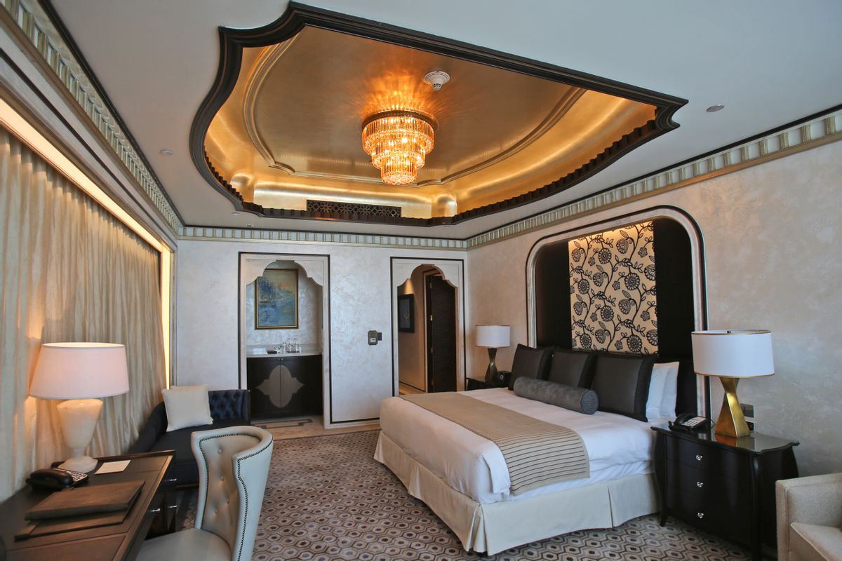 This May 19, 2014 photo shows one of the three bedrooms in the Abu Dhabi Suite at the St. Regis in Abu Dhabi, United Arab Emirates. The nearly 24,000 square foot two-story suite, which sells for a nightly rate of $21,500, is suspended 720 feet above ground between the two buildings of the Nation Towers development. It has three bedrooms, a spa, a cinema, a bar area, two kitchens and a 360-degree panoramic view of the city, the islands, and the Sheikh Zayed Grand Mosque. The suite has 19 chandeliers made of Bohemian crystal, and an elevator that takes guests to ground level in total privacy, bypassing the rest of the hotel.  (AP Photo/Kamran Jebreili)