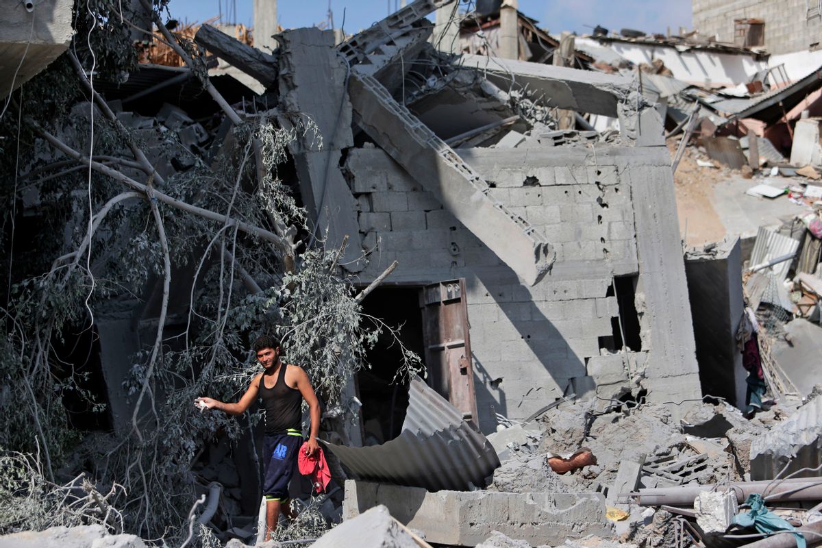 A Palestinian shows his pet bird which he managed to catch amid the rubble of houses destroyed by Israeli strikes in Beit Hanoun, northern Gaza Strip, Sunday, July 27, 2014. Hamas on Sunday agreed to observe a 24-hour humanitarian truce ahead of a major Muslim holiday after initially rejecting such an offer by Israel, as the two sides wrangled over setting the terms of a lull the international community hopes can be expanded into a more sustainable truce. (AP Photo/Lefteris Pitarakis) (AP)