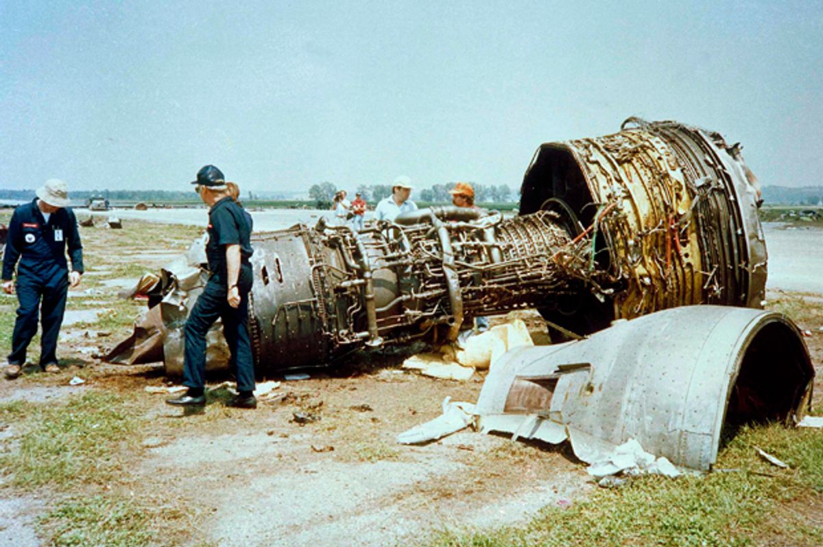 Investigators for the National Transportation Safety Board look over one of the burned jet engines of a United Airlines DC-10 that crashed  while trying to make an emergency landing on July 19, wreckage shown July 22, 1989. There are 109 confirmed deaths in the tragedy. (AP Photo/Sioux City Journal Pool/Ed Porter)   (Ed Porter)