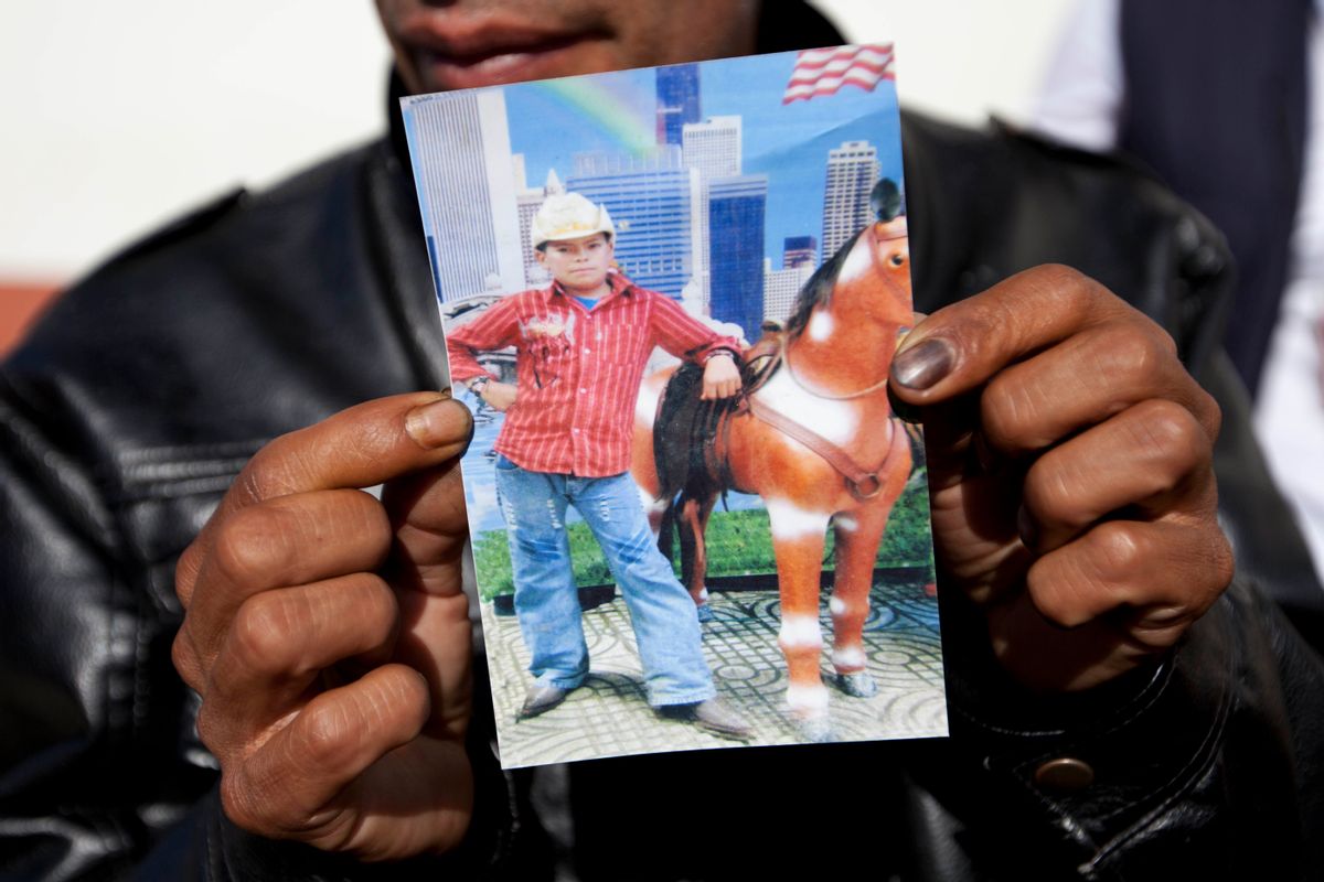 Francisco Ramos holds up a picture of his son, whose decomposed body was found in the Texas desert, as he waits for the arrival of his son's body, in Customs, in Guatemala City, Friday, July 11, 2014. The remains of Gilberto Francisco Ramos, the 15 year old boy who died in the Rio Grande Valley of South Texas, trying to reach the United States alone, was delivered to his family on Friday. (AP/Moises Castillo)