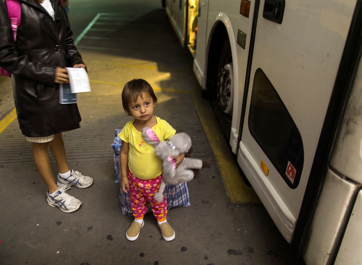 In this photo taken July 1, 2014, two-year-old Adriana Ortez holds her stuffed animal, as she and her mother, Dayana Ortez, of El Salvador, wait to board a bus leaving the city bus station in McAllen, Texas. Ortez and her daughter, were released on their own recognizance by U.S. Customs and Border Protection Services after entering the illegally into the U.S. from Mexico. The mother and daughter were heading to Los Angles to reunite with family. (AP Photo/Austin American-Statesman, Rodolfo Gonzalez) (AP)