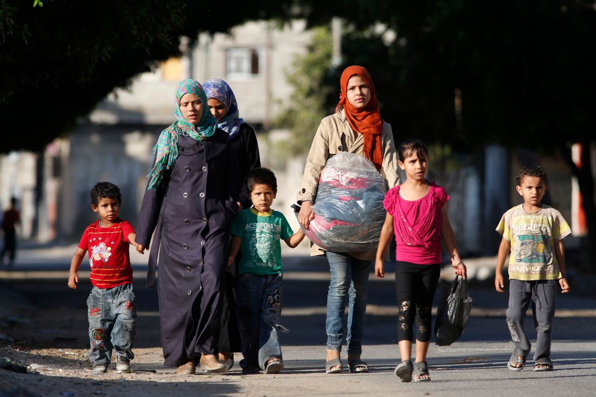 Palestinians flee their homes in the Zeitoun neighbourhood of Gaza City, after Israel had airdropped leaflets warning people to leave the area, Wednesday, July 16, 2014.   (AP/Lefteris Pitarakis)