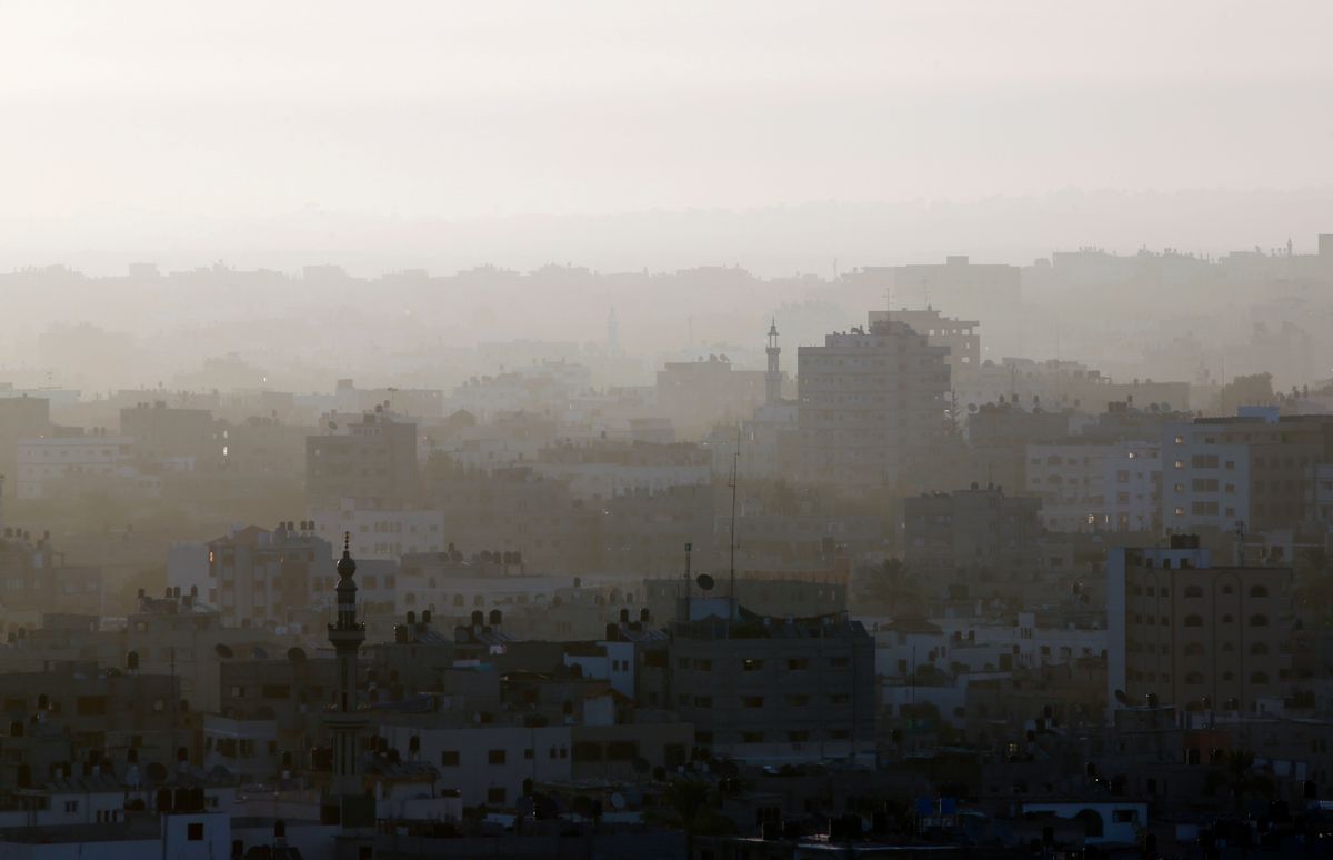 A hazy Gaza City is seeen in northern Gaza strip early Friday, July 18, 2014. The heavy thud of tank shells, often just seconds apart, echoed across the Gaza Strip early Friday as thousands of Israeli soldiers launched a ground invasion, escalating a 10-day campaign of heavy air bombardments to try to destroy Hamas' rocket-firing abilities and the tunnels militants use to infiltrate Israel. (AP Photo/Lefteris Pitarakis)  (AP)