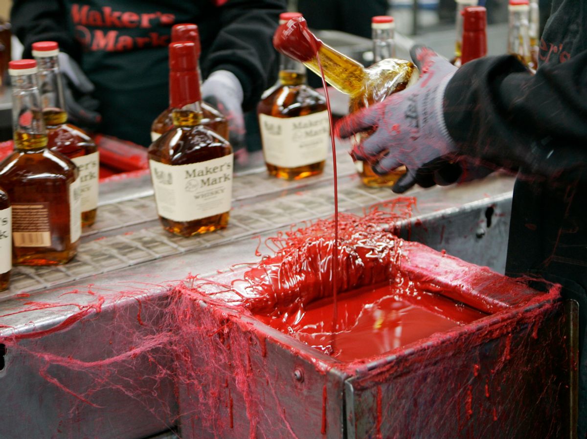 FILE - In this Wednesday, April 8, 2009, file photo, a bottle of Maker's Mark bourbon is dipped in red wax during a tour of the distillery in Loretto, Ky. Kentucky bourbon makers have stashed away their largest stockpiles in more than a generation due to resurgent demand for the venerable brown spirit. (AP Photo/Ed Reinke, File) (AP)