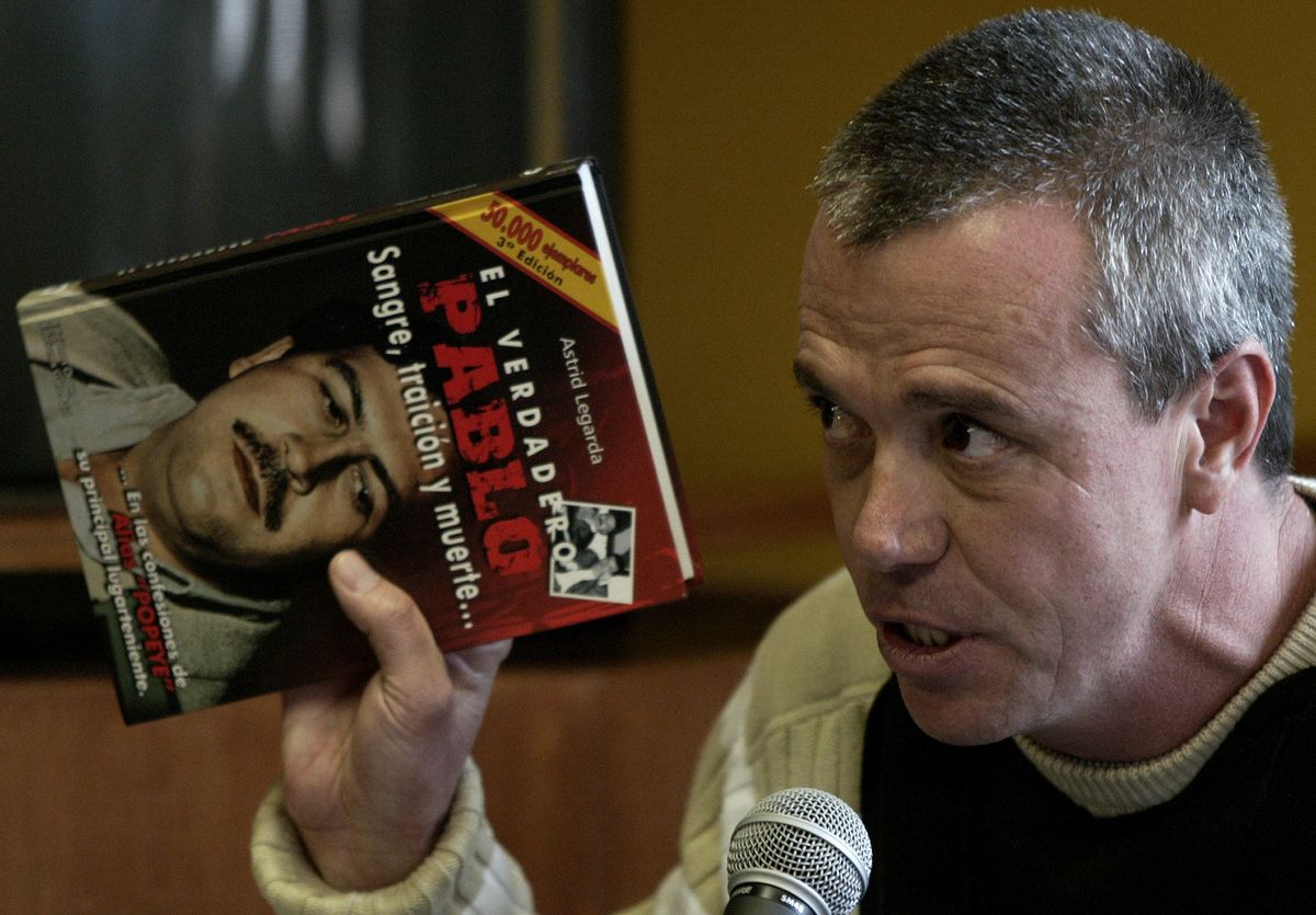 FILE - In this  June 27, 2006, file photo, John Jairo Velasquez, a former hit man for Pablo Escobar, gives his testimony while holding a book titled "The True Pablo, Blood, Treason, and Death," during the trial against Alberto Santofimio Botero in Bogota, Colombia. Velasquez, better known by his nickname Popeye, was released Tuesday Aug. 26, 2014, under heavy police surveillance from a maximum security prison northeast of Bogota after 23 years behind bars for plotting the murder of a former presidential candidate. (AP Photo/ William Fernando Martinez, File) (AP)