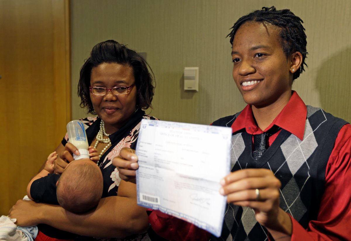 Kelly Noe, right, stands with her partner Kelly McCracken, as Noe holds a birth certificate for their daughter that has both of their names on it, Wednesday, Aug. 6, 2014, in Cincinnati. The couple are plaintiffs in the Ohio gay marriage case heard Wednesday in Cincinnati. A three judge panel of the 6th U.S. Circuit Court of Appeals heard arguments in six gay marriage fights from four states, Kentucky, Michigan, Ohio and Tennessee. (AP Photo/Al Behrman) (AP)