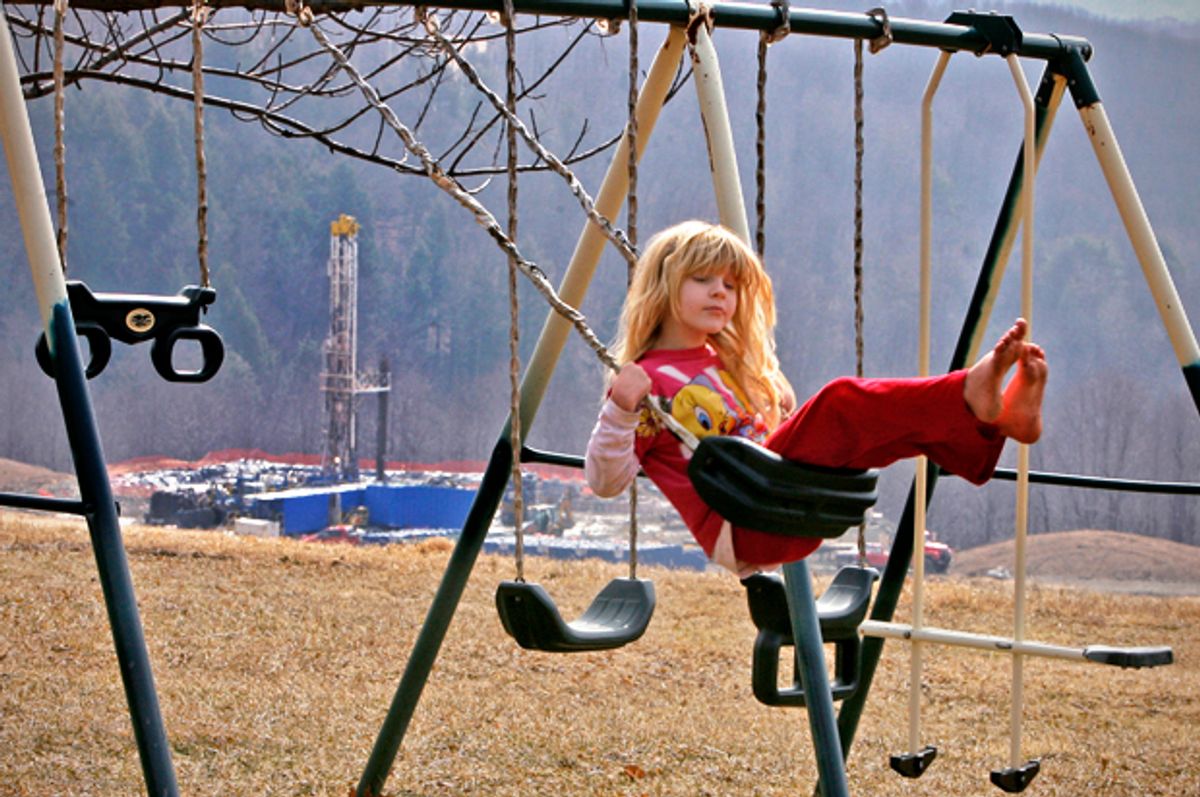 Rachel Farnelli rides on her backyard swing that overlooks the Gesford #3 natural gas well in Dimock, Pennsylvania, March 7, 2009.       (Reuters/Tim Shaffer)