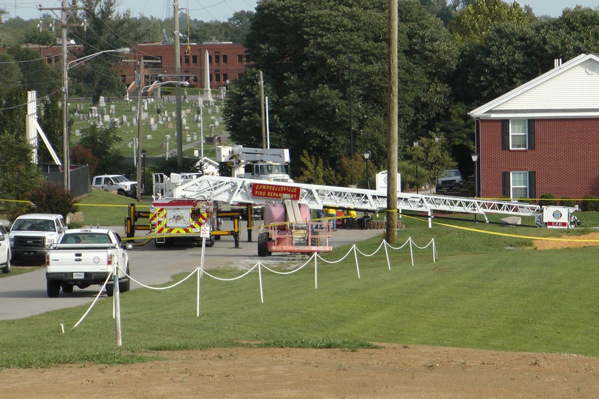 A Campbellsville Fire Department truck with the ladder extended remained at the scene where two firefighters were injured during an ice bucket challenge during a fundraiser for ALS on Thursday, Aug. 21, 2014, in Campbellsville, Ky. Officials say the ladder got too close to a power line and electricity traveled to the ladder, electrocuting the firefighters. (AP Photo/Dylan Lovan)  (AP)
