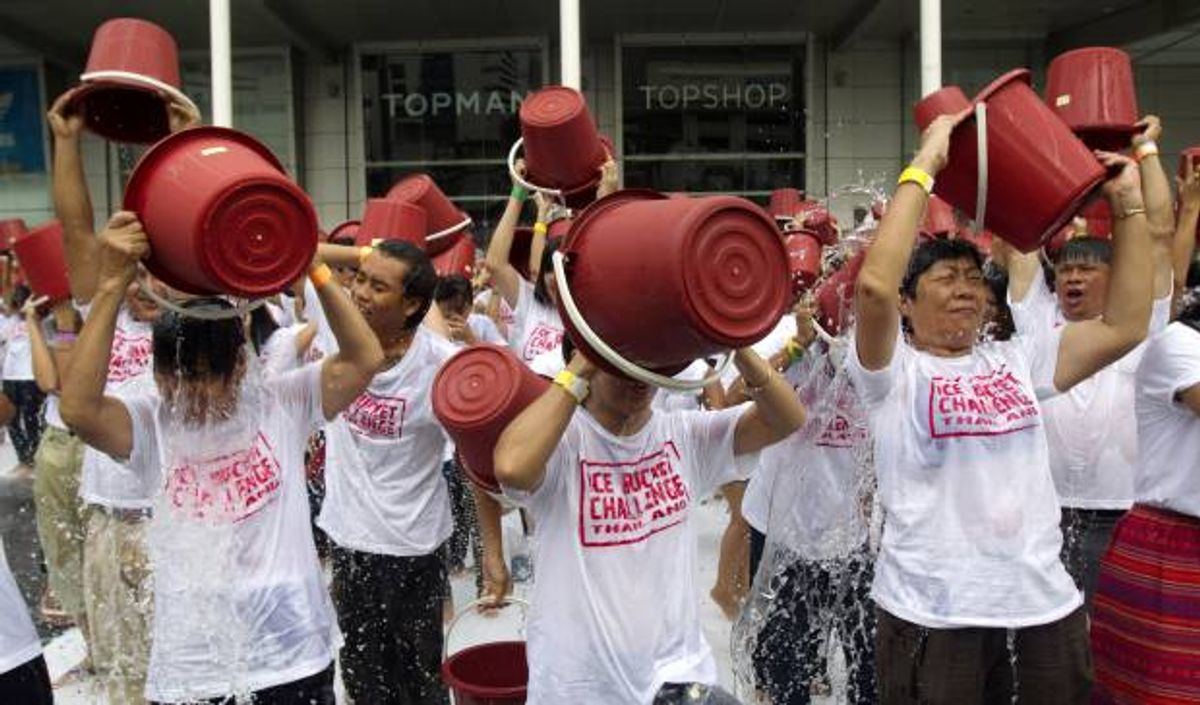 People pour ice water over themselves during an "ice bucket challenge" fund raising event in Bangkok  (AP Photo/Sakchai Lalit)