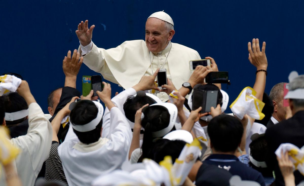 Pope Francis is greeted by the faithful upon his arrival for the Mass of Assumption of Mary at a stadium in Daejeon, south of Seoul, South Korea, Friday, Aug. 15, 2014. (AP Photo/Lee Jin-man, Pool) (Lee Jin-man)