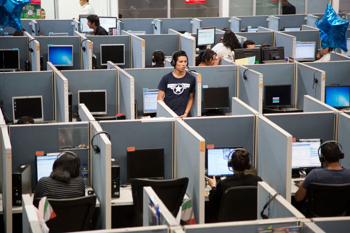 In this Aug. 13, 2014 photo, a man stands in the middle of the Firstkontact Center, a call center in the northern border city of Tijuana, Mexico. Many Mexicans deported under U.S. President Barack Obama are finding employment in call centers in Tijuana and other border cities. In perfect English, some dont even speak Spanish, they talk to American consumers who buy gadgets and gizmos, have questions about warrantees and complain about overdue deliveries. The call center industry has prospered in Mexican border cities as deportations spiked under U.S. President Barack Obama. (AP Photo/Alex Cossio) (AP)