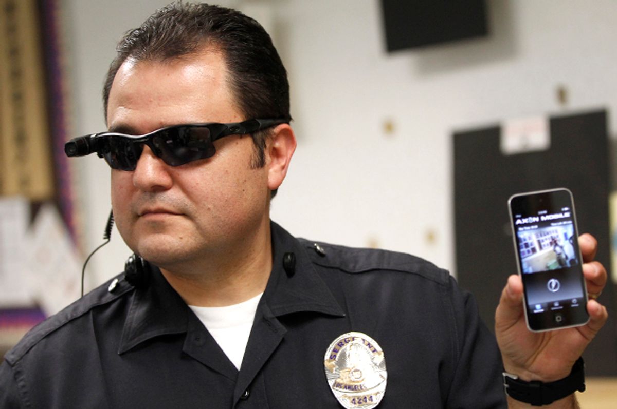 Los Angeles Police Sgt. Daniel Gomez demonstrates a video feed from his camera into his cellphone as on-body cameras are demonstrated for the media in Los Angeles, Jan. 15, 2014.                                  (AP/Damian Dovarganes)