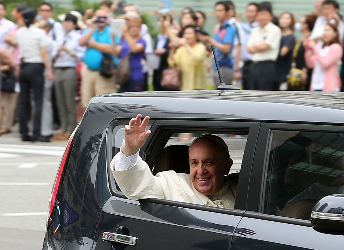 Pope Francis waves from a car after his arrival in Seoul, South Korea, Thursday, Aug. 14, 2014. As Francis became the first pope in 25 years to visit South Korea on Thursday, Seoul's never-timid rival, North Korea, made its presence felt by firing three short-range projectiles less than an hour before he arrived, officials said. (AP Photo/Yonhap, Lim Hun-jung) KOREA OUT     (Lim Hun-jung)