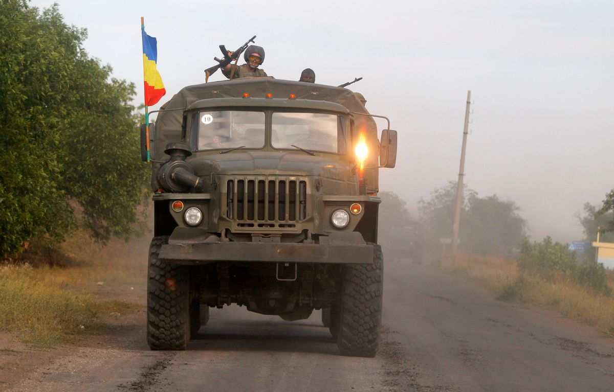 Pro-Russian rebels ride on a truck in the town of Krasnodon, eastern Ukraine, Sunday, Aug. 17, 2014. A column of several dozen heavy vehicles, including tanks and at least one rocket launcher, rolled through rebel-held territory on Sunday.(AP Photo/Sergei Grits) (AP)