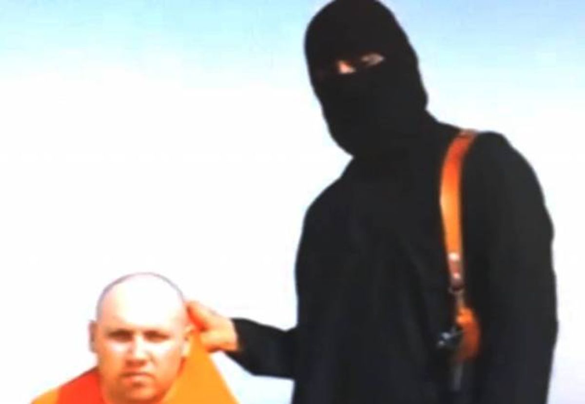 This still image from an undated video released by Islamic State militants on Tuesday, Aug. 19, 2014, purports to show journalist Steven Sotloff being held by the militant group.   (Associated Press)