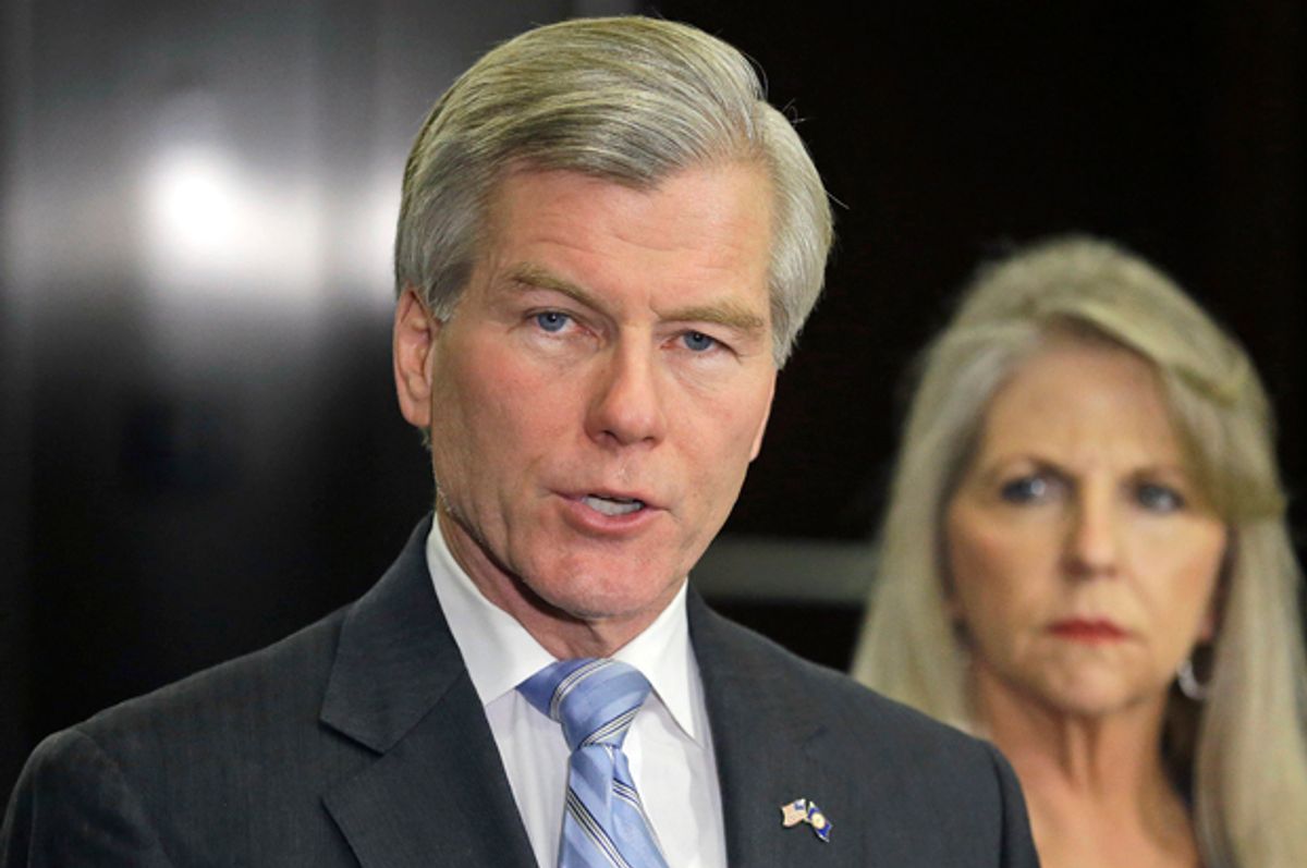 Bob McDonnell makes a statement as his wife, Maureen, listens during a news conference in Richmond, Va., April 24, 2014.         (AP/Steve Helber)