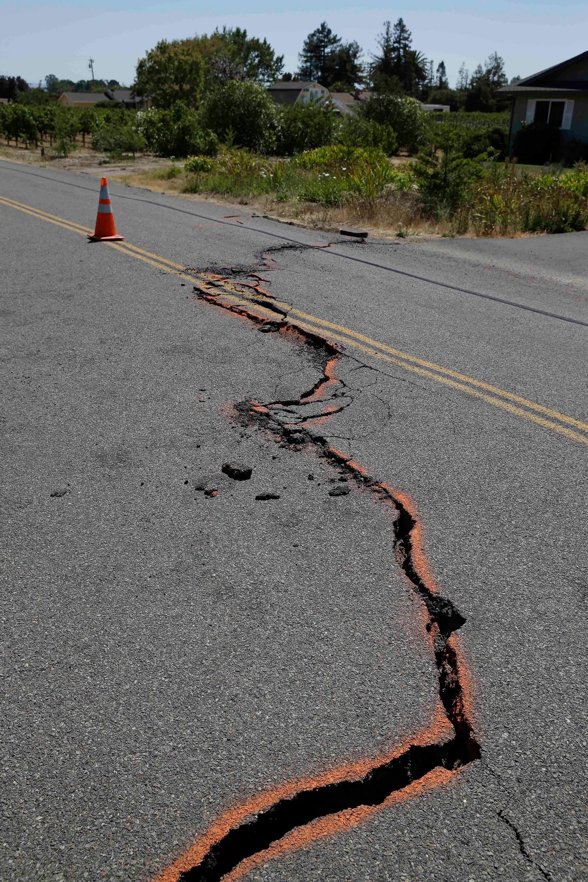 FILE - In this Aug. 24, 2014 file photo, a cracked section of roadway is shown in the Carneros district of Napa, Calif., following an earthquake. Emerging data on last months Northern California earthquake is explaining why the city of Napa suffered so much of the damage.  (AP Photo/Eric Risberg, File) (AP)