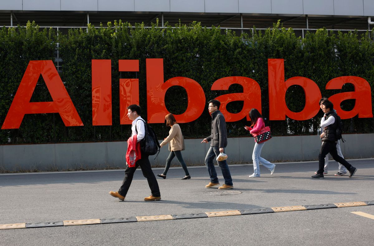 In this March 17, 2014 file photo, people walk past a company logo at the Alibaba Group headquarters in Hangzhou, in eastern China's Zhejiang province. (AP)