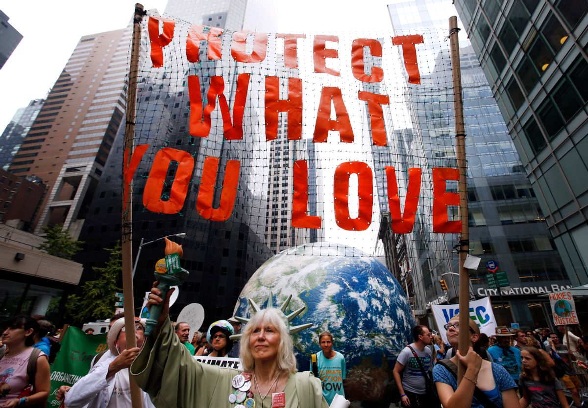 Demonstrators make their way down Sixth Avenue  in New York during the People's Climate March Sunday, Sept. 21, 2014. (AP/Jason DeCrow)