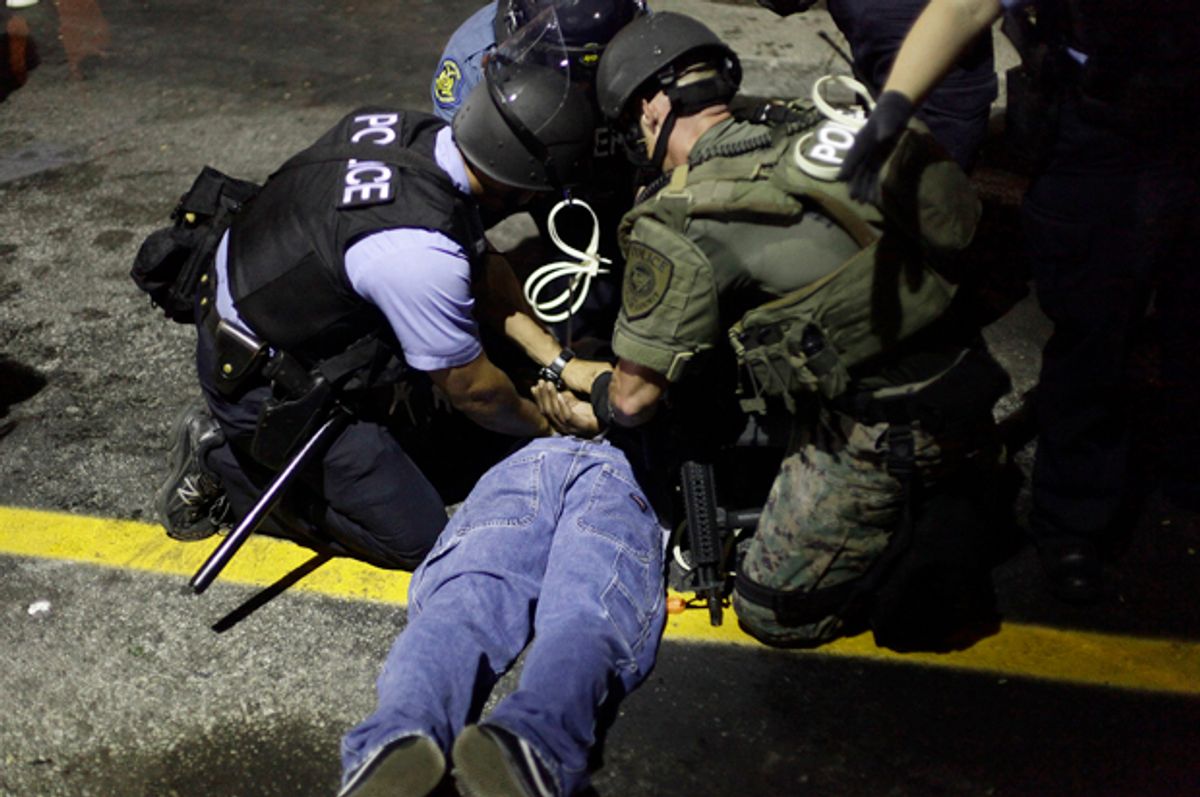 Police in riot gear detain a demonstrator in Ferguson, Missouri, Aug. 19, 2014.                (Reuters/Joshua Lott)