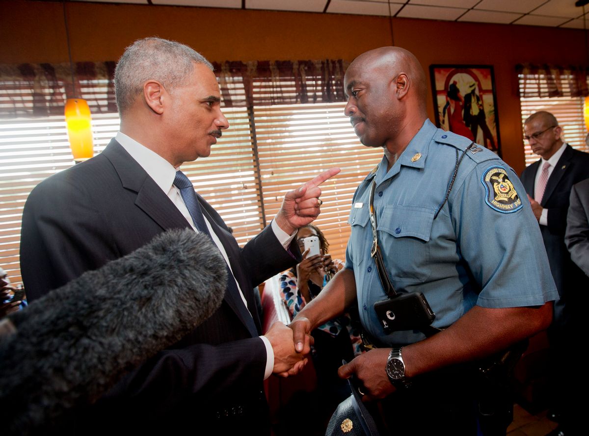 FILE - In this Aug. 20, 2014 file photo, Attorney General Eric Holder talks with Capt. Ron Johnson of the Missouri State Highway Patrol at Drake's Place Restaurant in Florrissant, Mo.  The Justice Department plans to open a wide-ranging investigation into the practices of the Ferguson, Missouri, Police Department following the shooting last month of an unarmed black 18-year-old by a white police officer in the St. Louis suburb, a person briefed on the matter said Wednesday, Sept. 3, 2014.  (AP Photo/Pablo Martinez Monsivais, File-Pool) (AP)