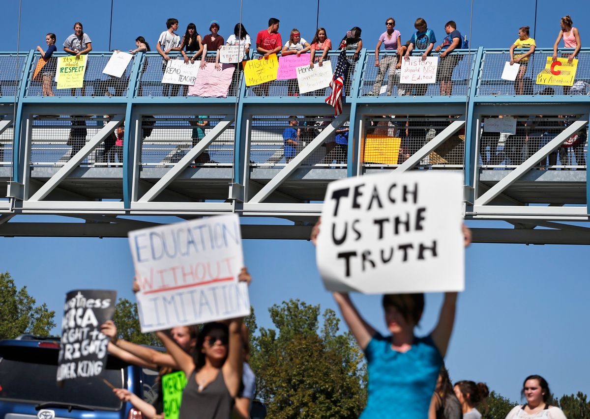 Students line a busy intersection and overpass protesting against a Jefferson County School Board proposal to emphasize patriotism and downplay civil unrest in the teaching of U.S. history, in the Denver suburb of Littleton, Colo., Thursday, Sept. 25, 2014. Several hundred students walked out of class Thursday in the fourth straight day of protests in Jefferson County. (AP Photo/Brennan Linsley)  (AP)