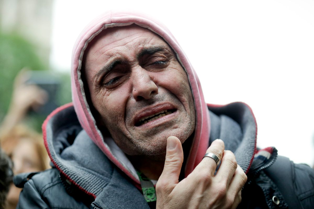 In this Friday, Sept. 5, 2014 photo, a man cries as mourners wait for the departure of the funeral car transporting the remains of Argentine rock star Gustavo Cerati to a cemetery, in Buenos Aires, Argentina. Cerati died on Thursday, four years after a stroke put him in a coma and ended the career of one of Latin America's most influential musicians. (AP Photo/Victor R. Caivano) (AP)