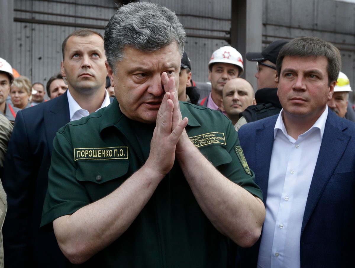 Ukrainian President Petro Poroshenko speaks to local workers during his visit to the Ilich Iron and Steel Works in the southern coastal town of Mariupol, Ukraine, Monday, Sept. 8, 2014. Poroshenko made a surprise trip Monday to a key city in southeastern Ukraine as a cease-fire between Russian-backed rebels and Ukrainian troops appeared to be largely holding. (AP Photo/Sergei Grits) (AP)