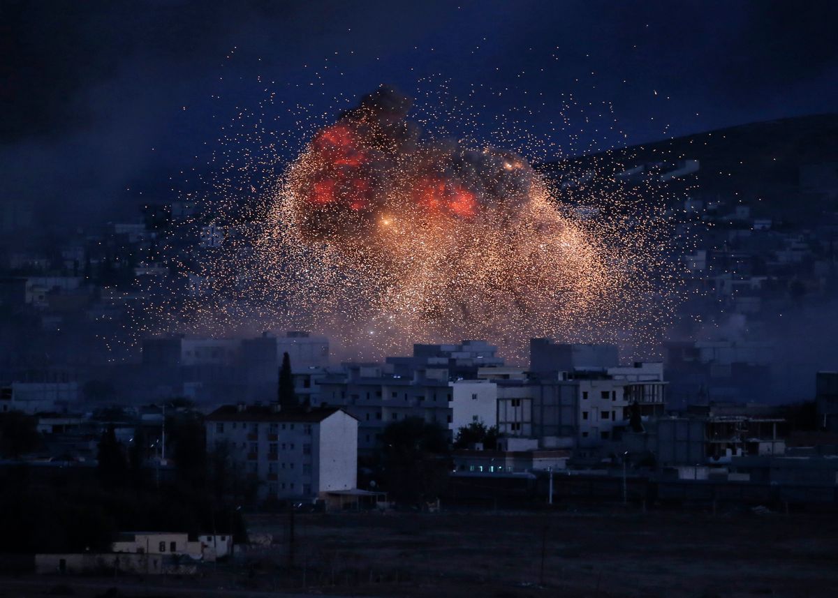 AP10ThingsToSee - Thick smoke and flames from an airstrike by the U.S.-led coalition rise in Kobani, Syria, as seen from a hilltop on the outskirts of Suruc, at the Turkey-Syria border, Monday, Oct. 20, 2014. Kobani, also known as Ayn Arab, and its surrounding areas, has been under assault by extremists of the Islamic State group since mid-September and is being defended by Kurdish fighters. (AP Photo) (AP)