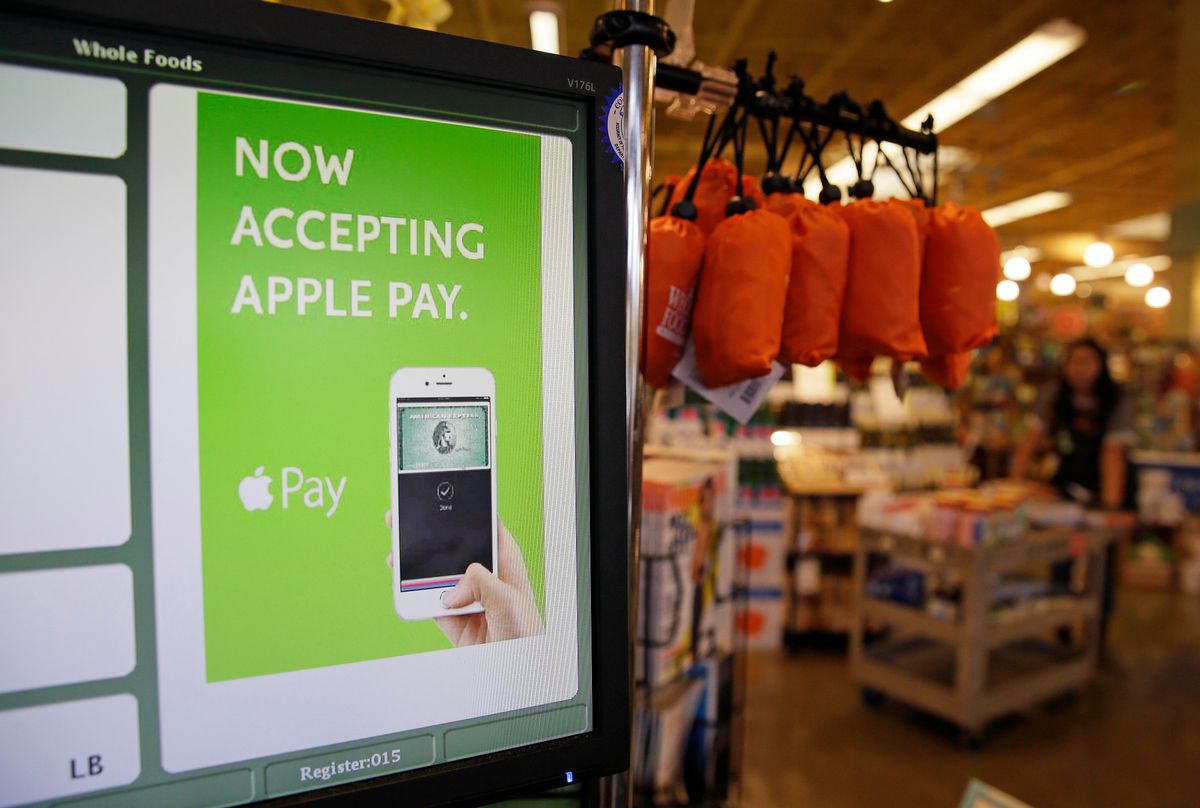 In this photo taken Friday, Oct. 17, 2014, a cash register terminal promotes usage of the new Apple Pay mobile payment system at a Whole Foods store in Cupertino, Calif. The new system launches on Monday. (AP Photo/Eric Risberg) (AP)