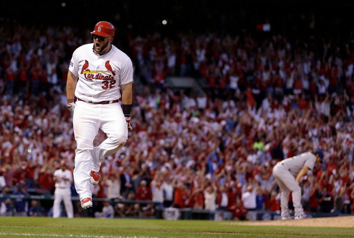 St. Louis Cardinals' Matt Adams celebrates after hitting a three-run home off Los Angeles Dodgers starting pitcher Clayton Kershaw, right, during the seventh inning of Game 4 of baseball's NL Division Series, Tuesday, Oct. 7, 2014, in St. Louis. The Cardinals won 3-2. (AP Photo/Jeff Roberson) (AP)