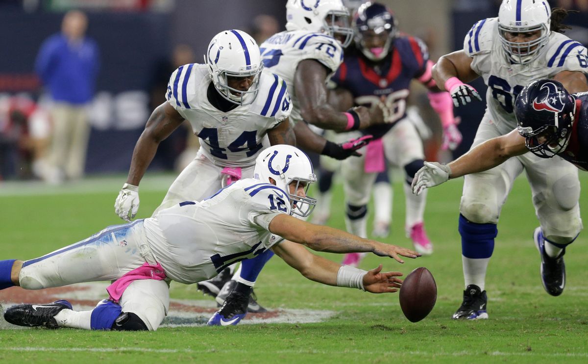 Indianapolis Colts' Andrew Luck (12) loses the ball during the second half of an NFL football game against the Houston Texans, Thursday, Oct. 9, 2014, in Houston. Houston's J.J. Watt recovered the ball and returned it for a 45-yard touchdown. (AP Photo/Patric Schneider) (AP)
