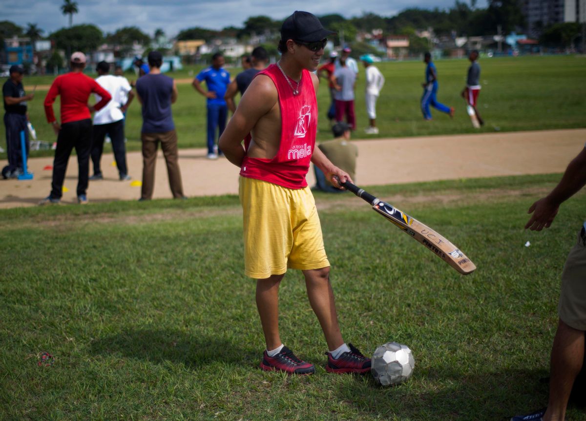 In this Sept. 24, 2014 photo, a cricket player waits his turn to play next to a soccer ball in Havana, Cuba, Monday, Sept. 29, 2014. Without a national tournament, Cuba has amateur tournaments  between Cuban teams and teams of students from cricket-playing countries. (AP Photo/Ramon Espinosa) (AP)