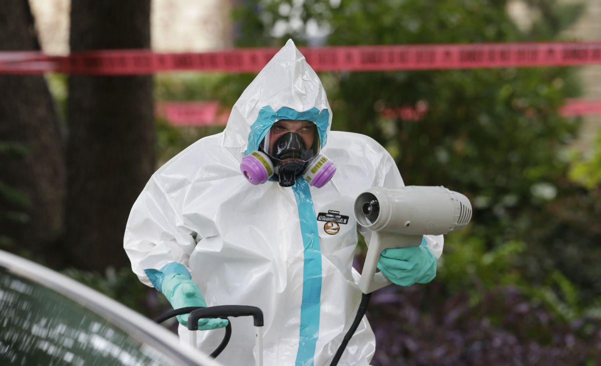 A hazmat worker cleans outside the apartment building of a hospital worker, Sunday, Oct. 12, 2014, in Dallas. The Texas health care worker, who was in full protective gear when they provided hospital care for Ebola patient Thomas Eric Duncan, who later died, has tested positive for the virus and is in stable condition, health officials said Sunday. (AP Photo/LM Otero) (AP)