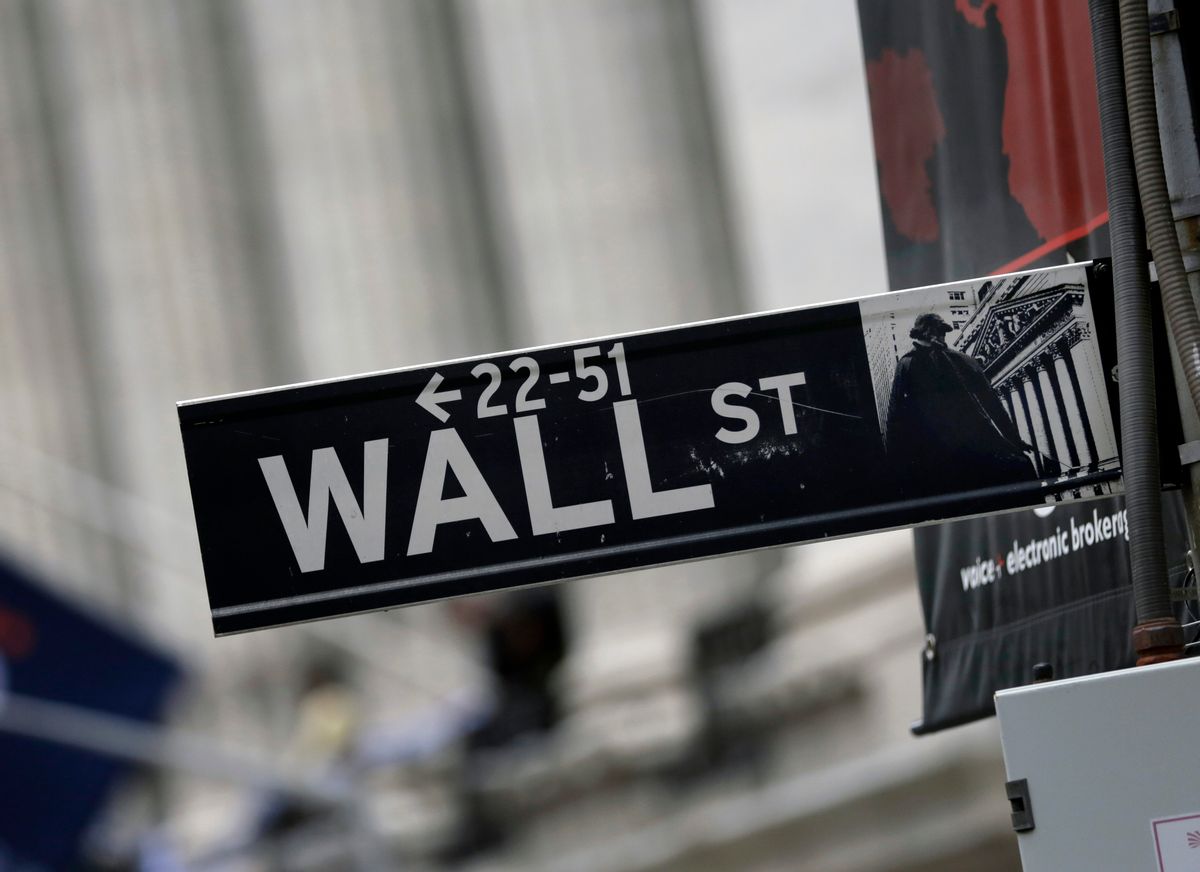 This Oct. 2, 2014 photo shows a Wall Street sign adjacent to the New York Stock Exchange, in New York. Earnings gains from General Motors, 3M and other big companies are driving stocks sharply higher in early trading Thursday, Oct. 23, 2014. (AP Photo/Richard Drew) (AP)