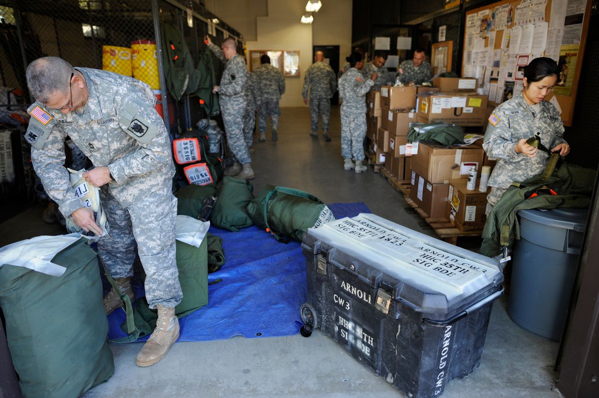 Soldiers from the 35th Theater Tactical Signal Brigade pack their gear as they prepare for deployment to west Africa to aid against the spread of the Ebola virus in Fort Gordon, Ga., Monday, Oct. 20, 2014. (AP Photo/The Augusta Chronicle, Michael Holahan) (AP)