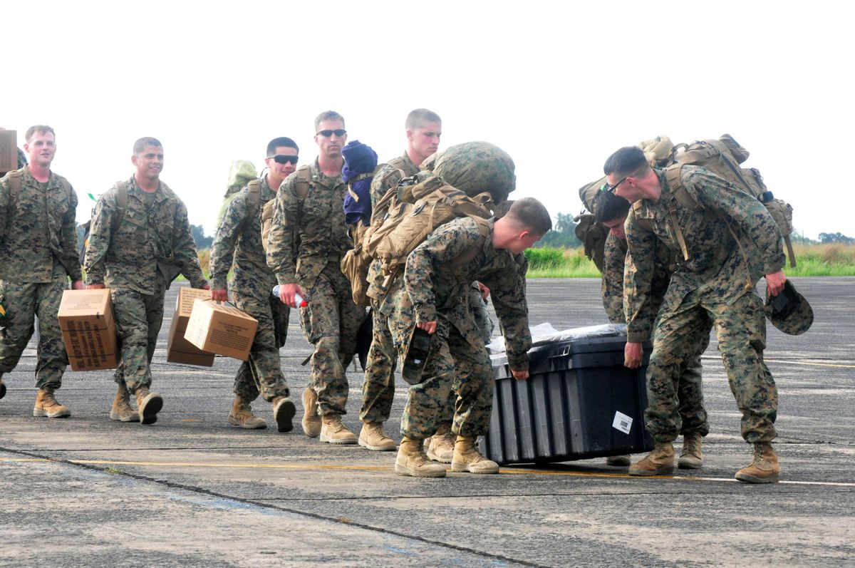 U.S marines arrival at the Roberts International airport in Monrovia, Liberia, Thursday, Oct. 9, 2014. Six U.S. military planes arrived Thursday at the epicenter of the Ebola crisis, carrying more aid and American Marines into Liberia, the country hardest hit by the deadly disease that has devastated West Africa and stirred anxiety across a fearful world. At a World Bank meeting in Washington, the presidents of several West African countries struggling with Ebola pleaded for help, with one calling the epidemic "a tragedy unforeseen in modern times." (AP Photo/Abbas Dulleh) (AP)